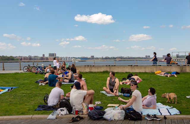 People lounging on the lawn at Christopher Street Pier, Sunday May 3rd, 2020.